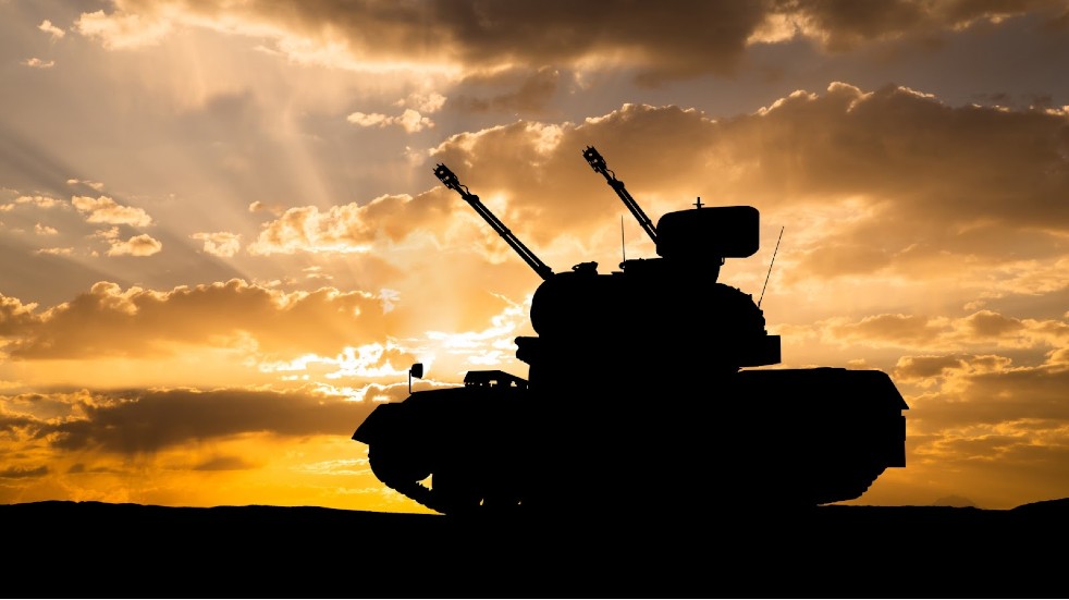 Military tank at sunset